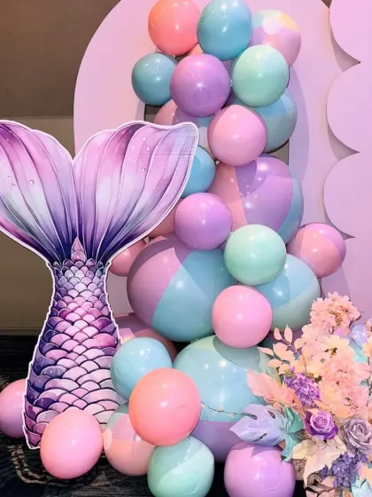 A beautiful mermaid tail cutout paired with pastel balloons. This makes for a perfect photo corner at any underwater-themed party.