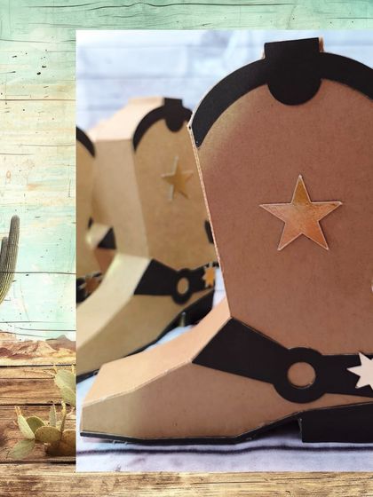 A close-up of the detailed cowboy boot gift boxes, complete with star cutouts and buckle details.