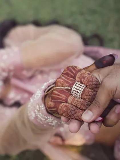 The beauty of a wedding is in the details. This close-up shot highlights the intricate henna and the joining of hands, symbolizing a new bond. We take an artistic approach to detail photography, finding creative ways to capture the elements that make your celebration unique.