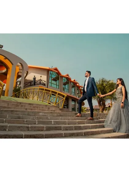 A grand, wide-angle shot of the couple on the steps of a modern building. This type of architectural photo creates a very powerful and stylish engagement portrait.