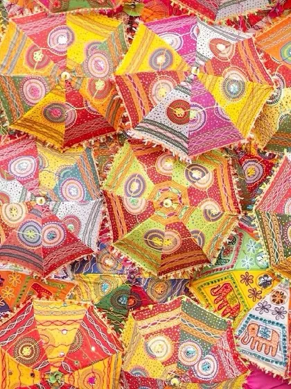 A backdrop made of colorful, handcrafted Rajasthani umbrellas. This installation for Devika and Harsh's event served as a vibrant photo wall and a celebration of local artistry.