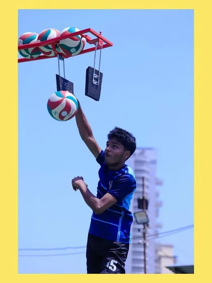 A player reaches for the ball on the spike trainer, demonstrating the height and extension we train for.