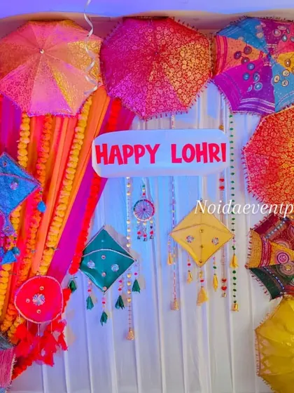 A colorful backdrop for a Lohri celebration, featuring vibrant Rajasthani umbrellas, kites, and marigold garlands to create a joyful and festive photo corner.