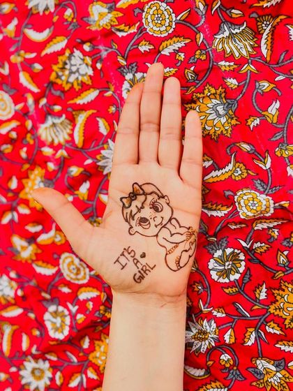 A full view of the 'It's a Girl' baby announcement mehndi. This charming and simple design is a wonderful way to share your happy news with the world.