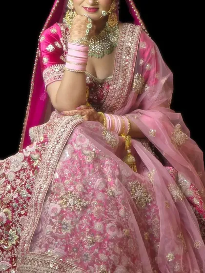 This stunning pink bridal lehenga has incredibly detailed floral embroidery all over the skirt. It's a statement piece available for rent for your big day.