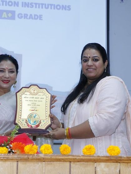 Guru Maa Smt. Ruby Mishra receiving the 'Mahila Unnati Samman' award, a responsibility she accepts with humility.
