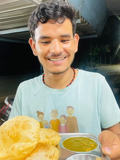 A happy customer enjoying our freshly made, phooli phooli (puffed up) pooris. That smile says everything about how good simple, well-made food can feel.