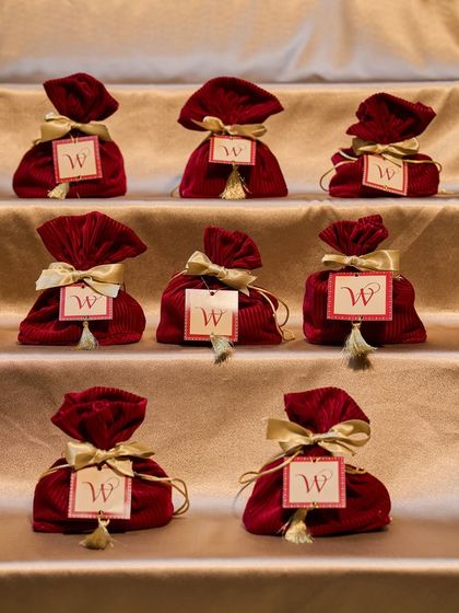 A lineup of our Festive Bundles, ready to be delivered. The rich maroon velvet and custom tags make these potlis a standout gift for any Diwali celebration.