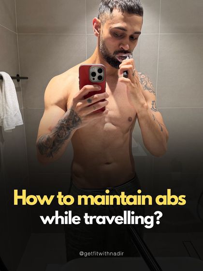 A bathroom selfie while brushing my teeth, introducing a series on how to maintain abs while traveling. It shows that fitness is integrated into my daily life.