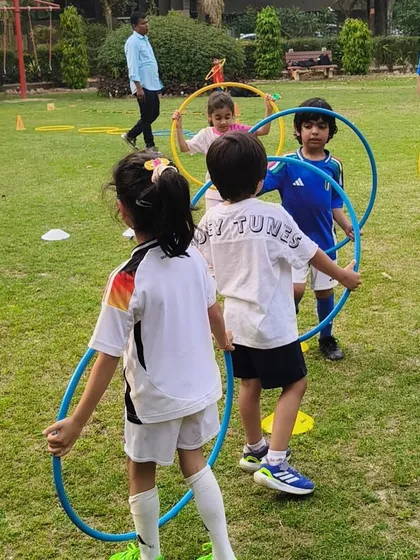 Teamwork makes the dream work, even at this age. Children in our First Kicks program learn to cooperate and move together through fun hula hoop exercises.
