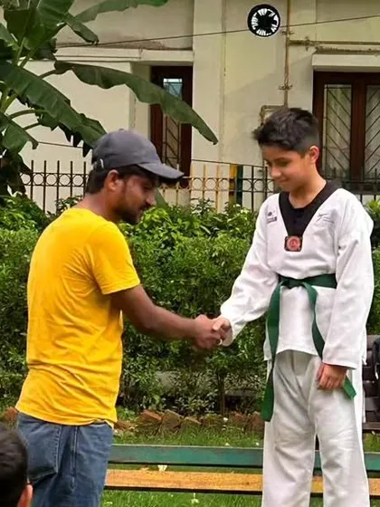 A handshake of congratulations. This student has demonstrated the skills required to advance to the next level.