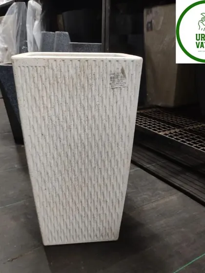 A square, tapered fiber pot with a textured white finish. This modern design works well in many different settings.