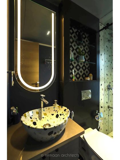 The attached bathroom for the daughter's room features a funky terrazzo-style sink and bold geometric tiles. It's a fun, youthful design that complements the bedroom's aesthetic.