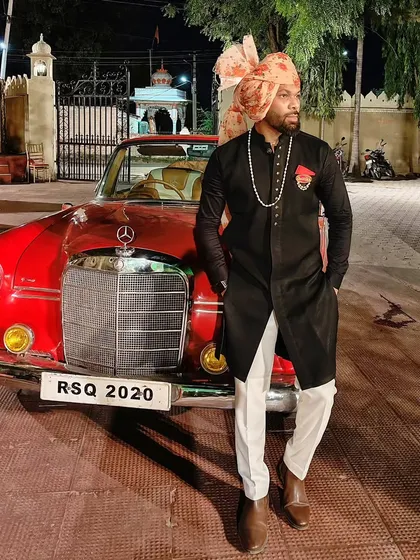 In the land of kings, you have to act like a prince. Posing with a vintage Mercedes at a royal-themed wedding in Udaipur.