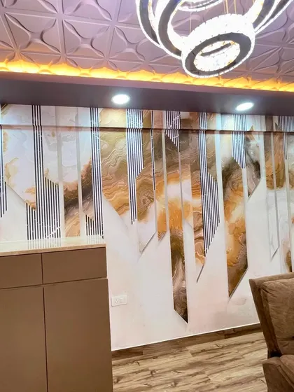 An abstract wallpaper design featuring geometric shards with marble and line patterns. This was installed in a living area to create a dynamic and contemporary feature wall that complements the modern furniture.