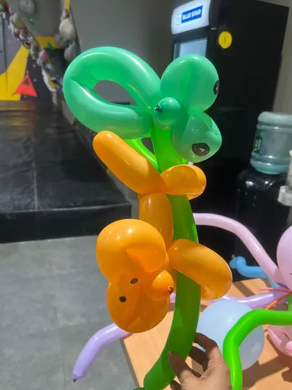 Balloon twisting is a fun art form. Our artists can create all sorts of amazing things, like this monkey climbing a tree.