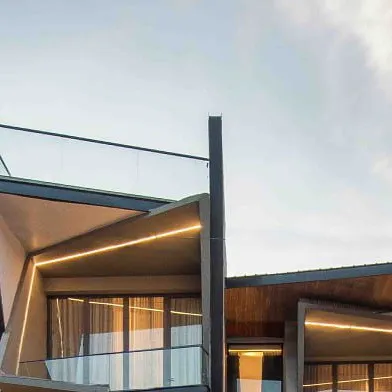 A close-up of the angled balconies at Casa Acentuada, showing the clean lines of the integrated lighting and glass railings.