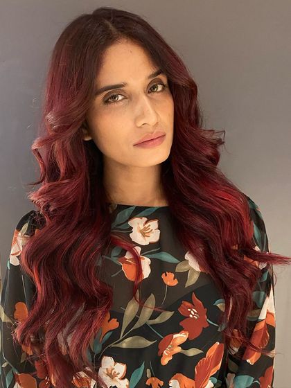 A beautiful cherry red hair color. This look is vibrant, fun, and full of personality.