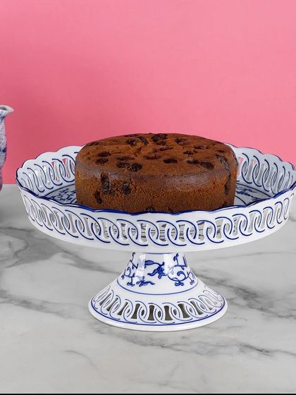 This blue pottery cake stand with its delicate open-work design is perfect for showcasing your baked creations. The traditional patterns add a touch of elegance to any celebration or high tea.