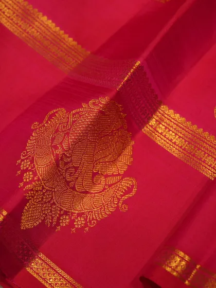 The soul of a Kanjivaram lies in its details. This close-up reveals the magnificent peacock motif, woven with pure gold zari, a symbol of royalty and grace that we meticulously craft into our heritage pallus.