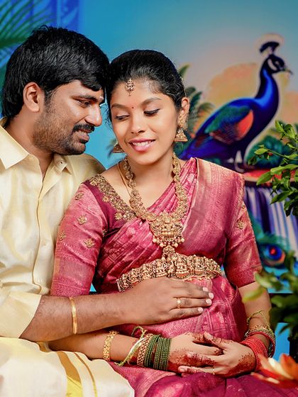 Capturing quiet, intimate moments amidst the celebration. The dad-to-be gently holds his wife as they share a look, surrounded by the beautiful decor of their baby shower.