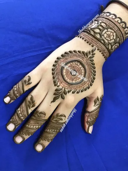 A lovely mandala design on the back of the hand with a floral cuff. This is a great option for someone who wants a traditional feel without the heavy coverage.