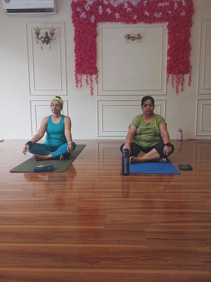 Two students seated and ready for our guided meditation. This is how we quiet the mind after working the body, integrating the physical practice with mental calm.