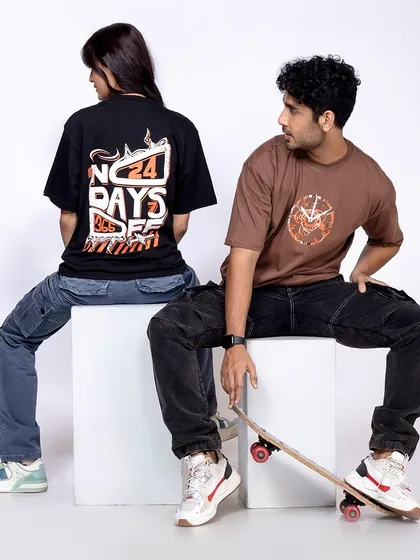 A shot of two models, male and female, in trendy oversized t-shirts and cargo pants. This image is perfect for a streetwear brand targeting a young, fashion-forward audience.
