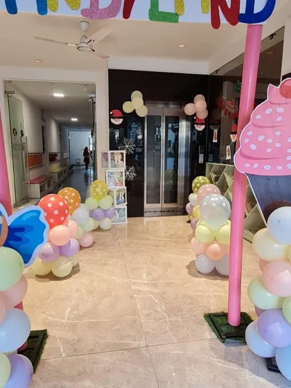 The indoor entrance for the Candyland party, with giant cupcake and ice cream decorations.