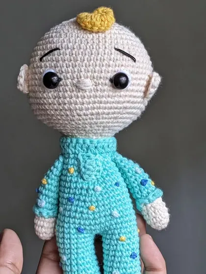 The JJ doll held in hand.