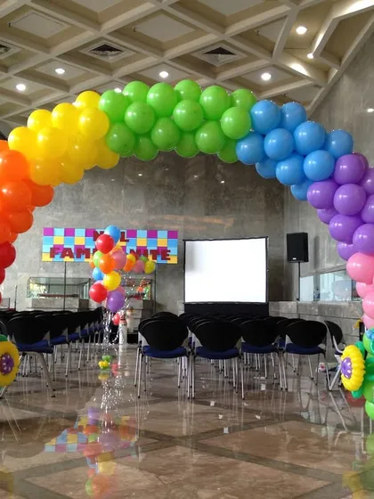 A classic rainbow balloon arch, perfect for adding a splash of color to any event. This large-scale installation is ideal for entrances at corporate family days or vibrant birthday parties.