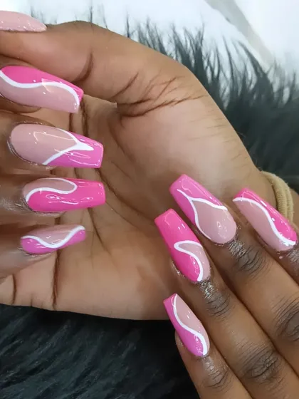 A playful abstract design with a mix of nude and bright pink nails, featuring bold white swirls on a long, square shape.