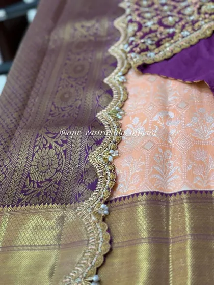 The full view of the peach and purple saree combination, highlighting the elegant embroidered border.