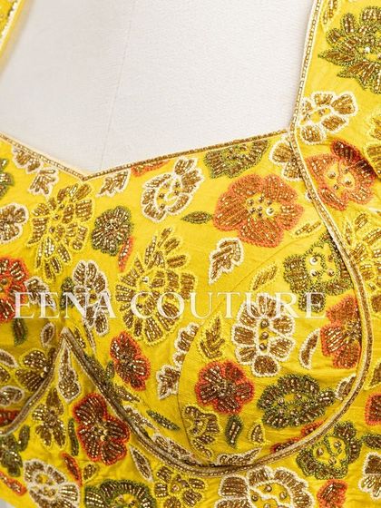 Another take on the yellow raw silk blouse, this piece features a classic Katori cut. The front is kept simple to highlight the fit, while the back and sleeves are adorned with a vibrant floral pattern in multi-colored beadwork.