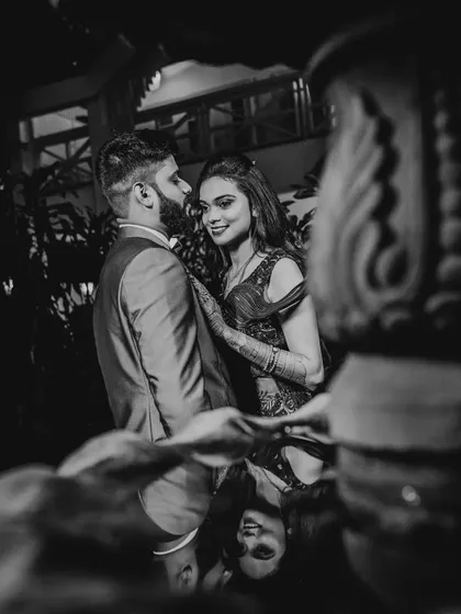 A creative black and white portrait with the couple's reflection captured on a surface. This adds an artistic and unique dimension to their engagement photos.