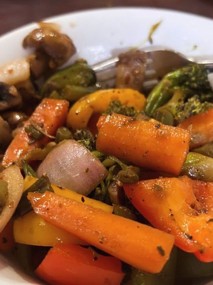A bowl of colorful sautéed vegetables, including broccoli, carrots, and mushrooms. A simple and delicious way to get your five-a-day.