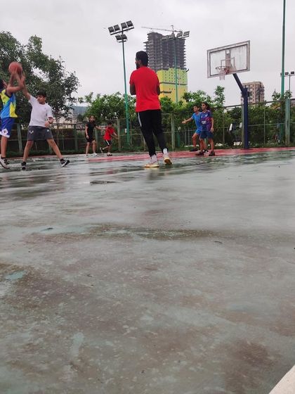 The game goes on, even on a wet court. This shows the resilience and passion of our players.