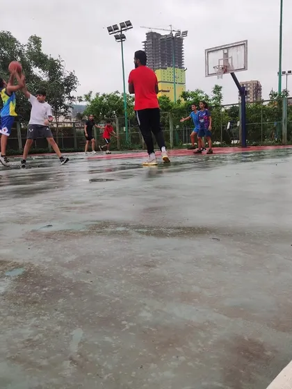 A player goes for a shot during a rainy practice match. We believe in embracing every challenge, including the weather.