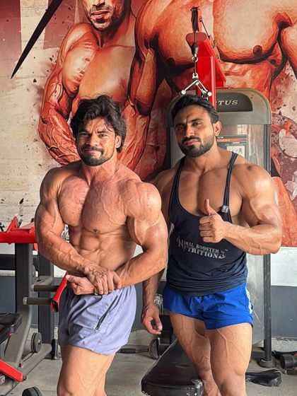 Posing with a fellow bodybuilder. Iron sharpens iron.