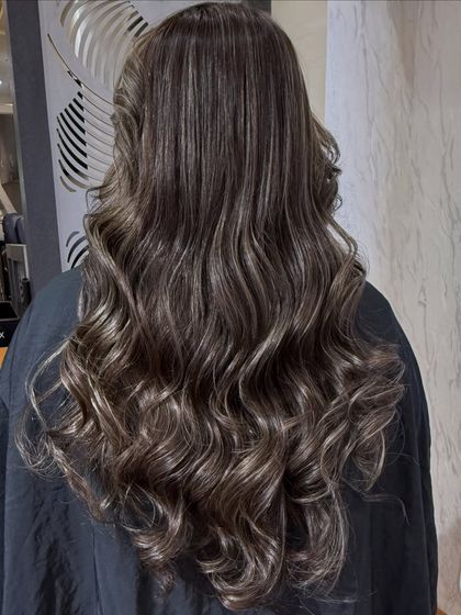 The final result of the Smokey Ash babylights. The hair is styled in soft waves to show off the intricate color work.