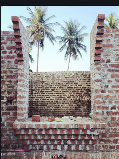 Construction in progress at the Samyak Yoga retreat. The air is filled with the earthy smell of lime mortar as the brick walls rise, framed against the coconut trees. This is what building with natural, traditional materials feels like.