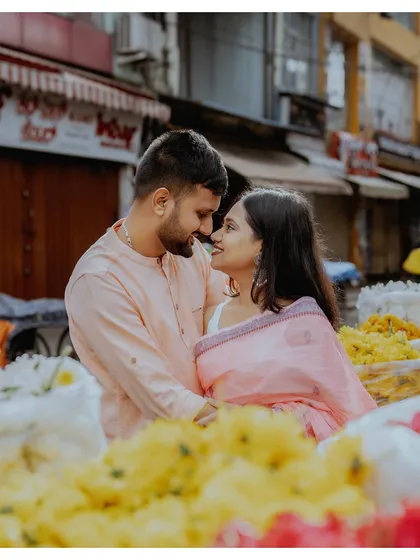 Finding a moment of intimacy amidst the vibrant chaos of a local flower market. This pre-wedding shoot shows how love can create a beautiful, quiet world of its own, no matter the setting.