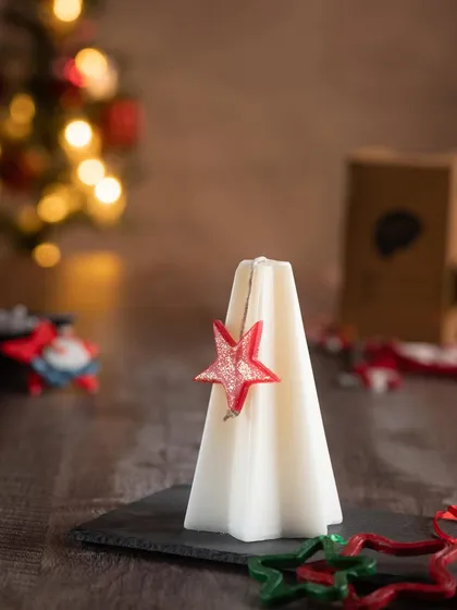 The minimalist tree candle in white, with a festive red star. These look great grouped together.
