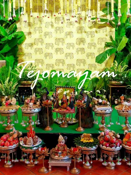 A Seemantham setup with a lush green backdrop of banana plants and elephant motifs, creating a rich and traditional atmosphere.