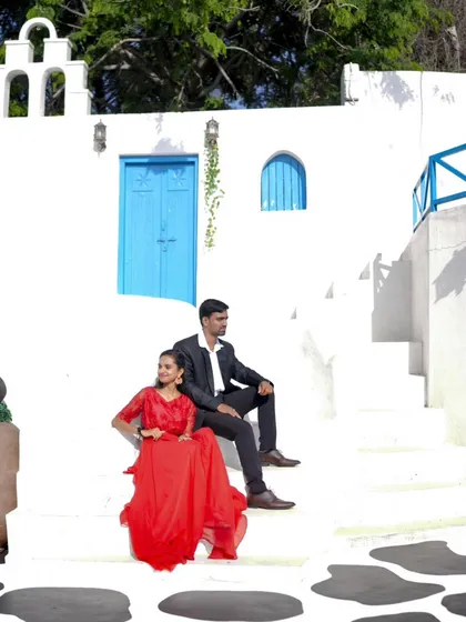 Another beautiful shot of the couple on the white steps, showing the clean and bright aesthetic of our Santorini location.