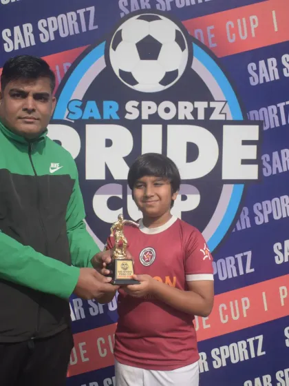 Another one of our young champions receiving his trophy at the Pride Cup. These moments build confidence and fuel the desire for future victories.
