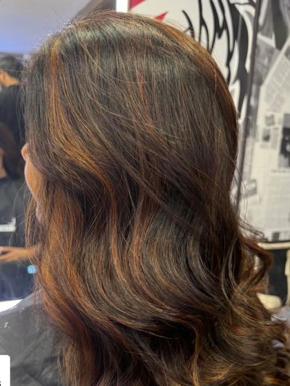 A close up of a rich color transformation. I used a mix of warm brown and copper tones to create this multi dimensional look, with soft waves to catch the light.