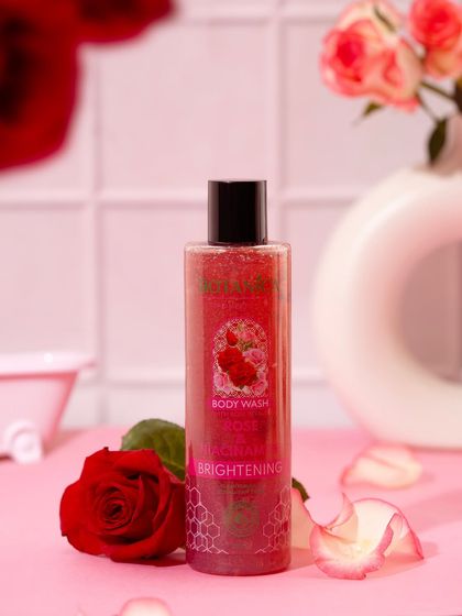 A romantic, bathroom-inspired scene for a rose-scented body wash. The soft pink tones, fresh roses, and miniature bathtub prop create a luxurious, pampering vibe.