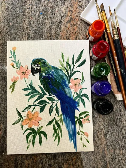 In addition to large murals, I also create detailed canvas paintings. This piece features a blue and green parrot surrounded by soft pink flowers, showcasing my fine brushwork and ability to create beautiful nature art for any interior space.