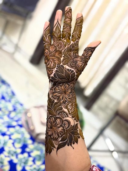 A close-up of the hibiscus design on the back of the hand.